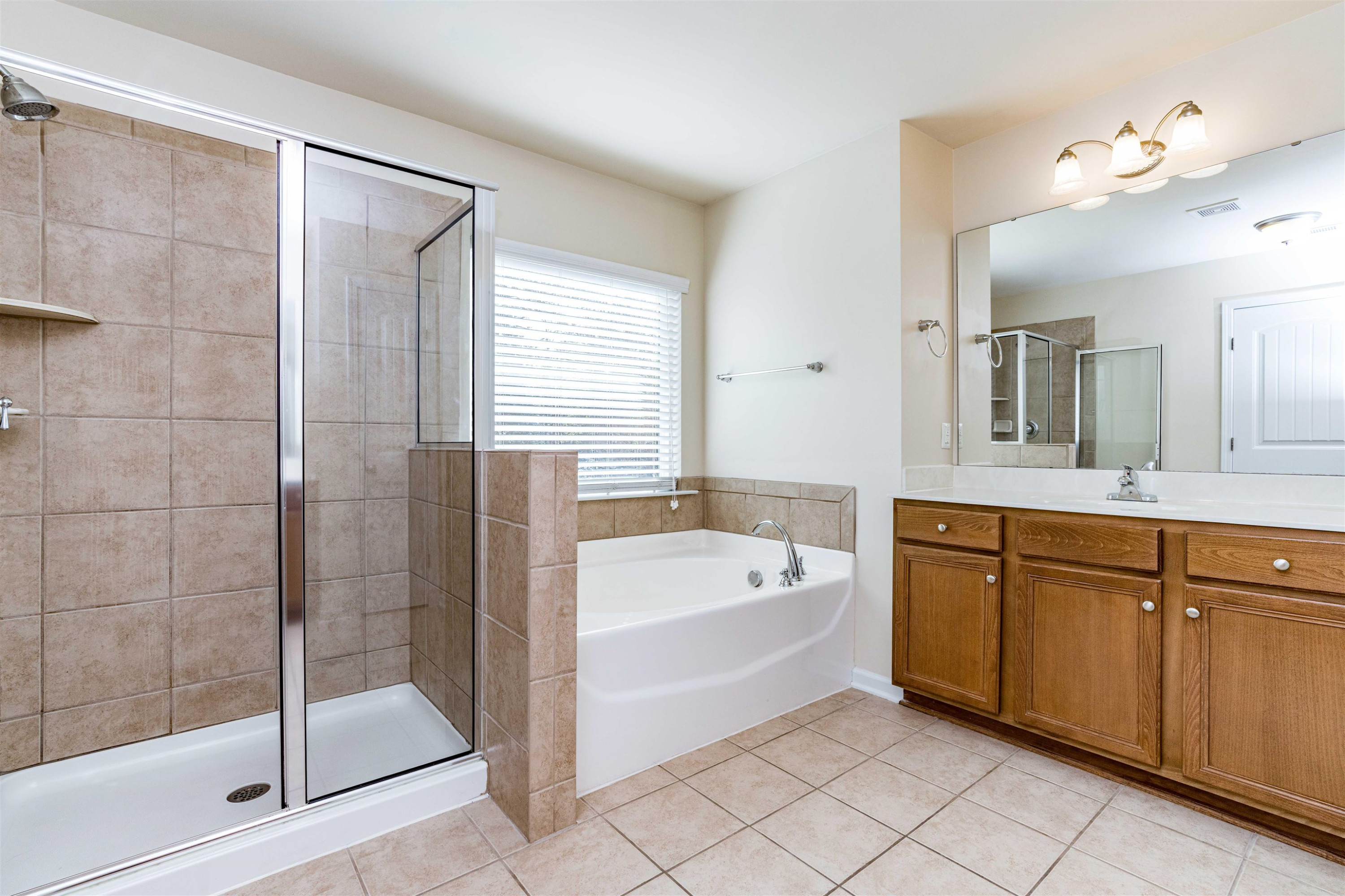 2081 Weston Green Loop Cary, NC 27513 - Photo 18 of 29 a spacious bathroom with a tub sink shower and mirror