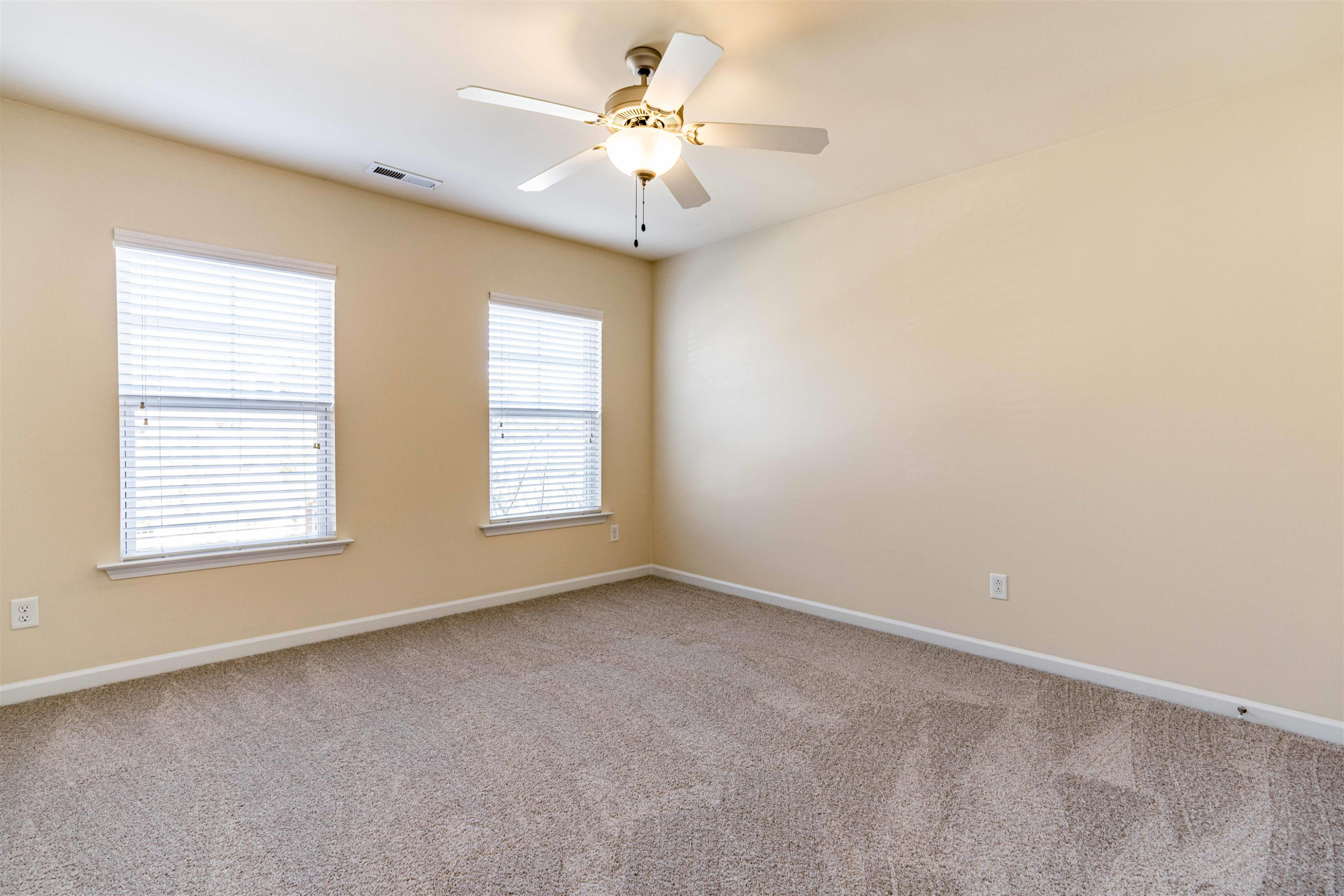 2081 Weston Green Loop Cary, NC 27513 - Photo 21 of 29 an empty room with windows and ceiling fan