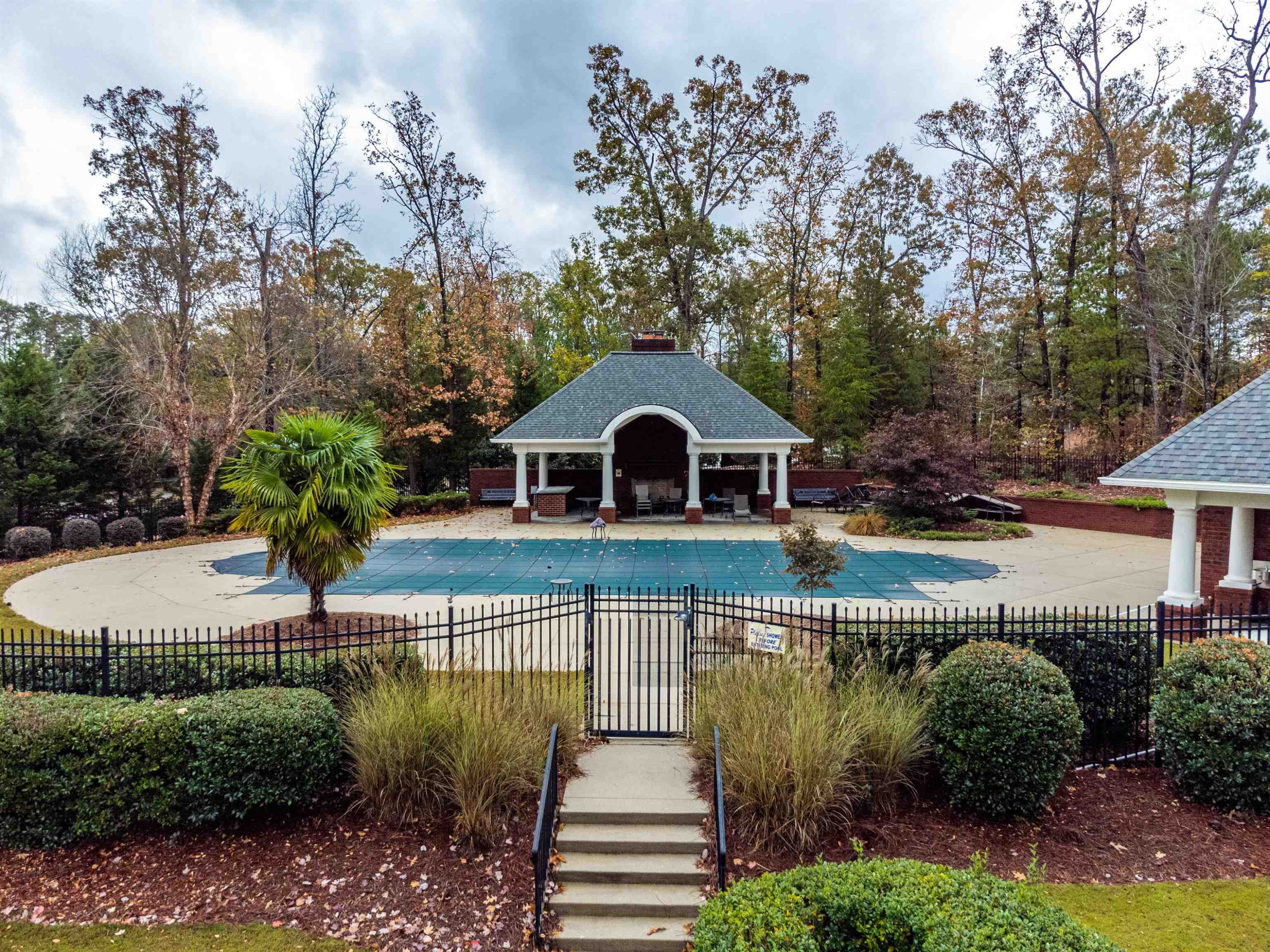 2081 Weston Green Loop Cary, NC 27513 - Photo 27 of 29 a view of a big house with large trees and plants next to yard