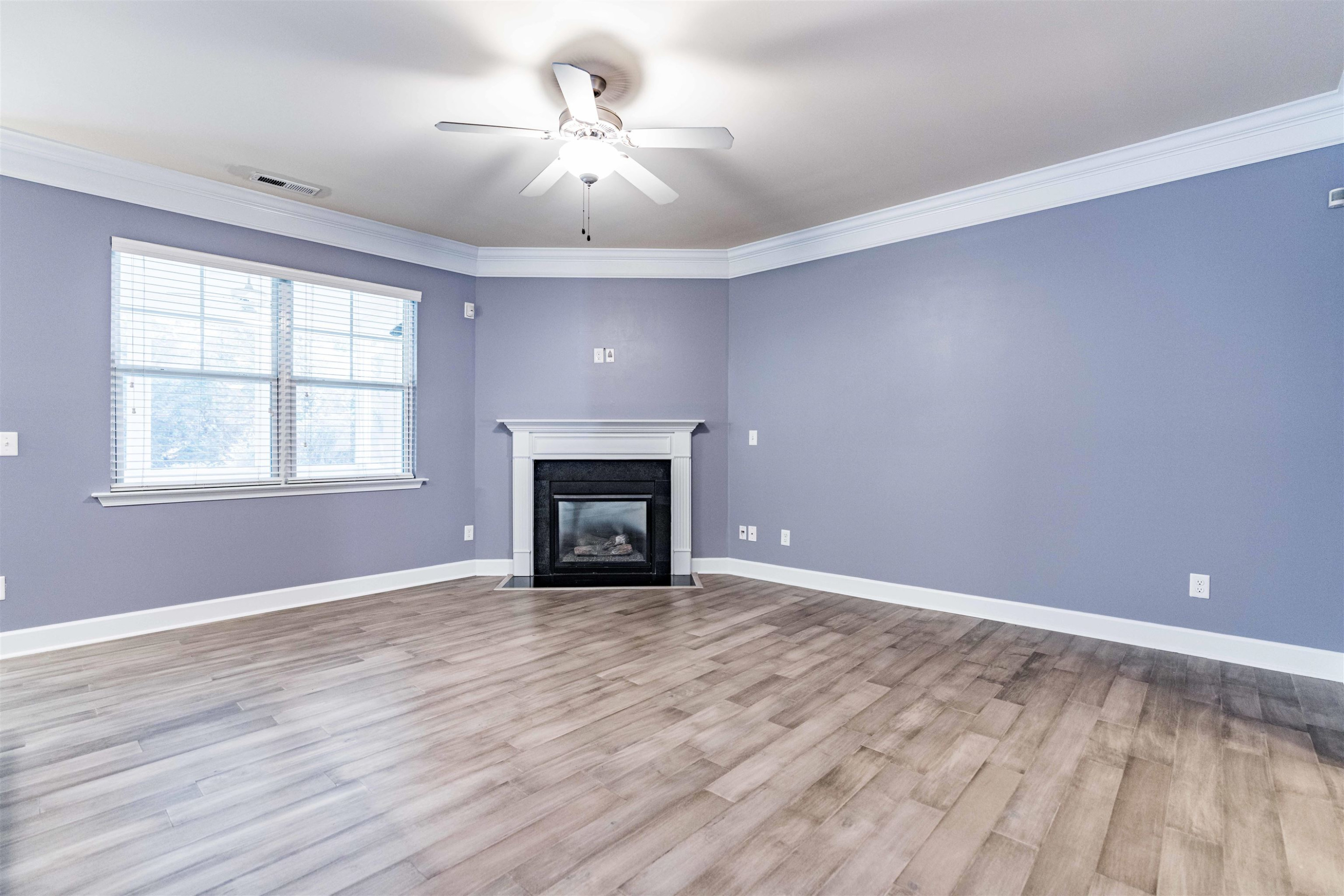 2081 Weston Green Loop Cary, NC 27513 - Photo 5 of 29 a view of an empty room with window and wooden floor