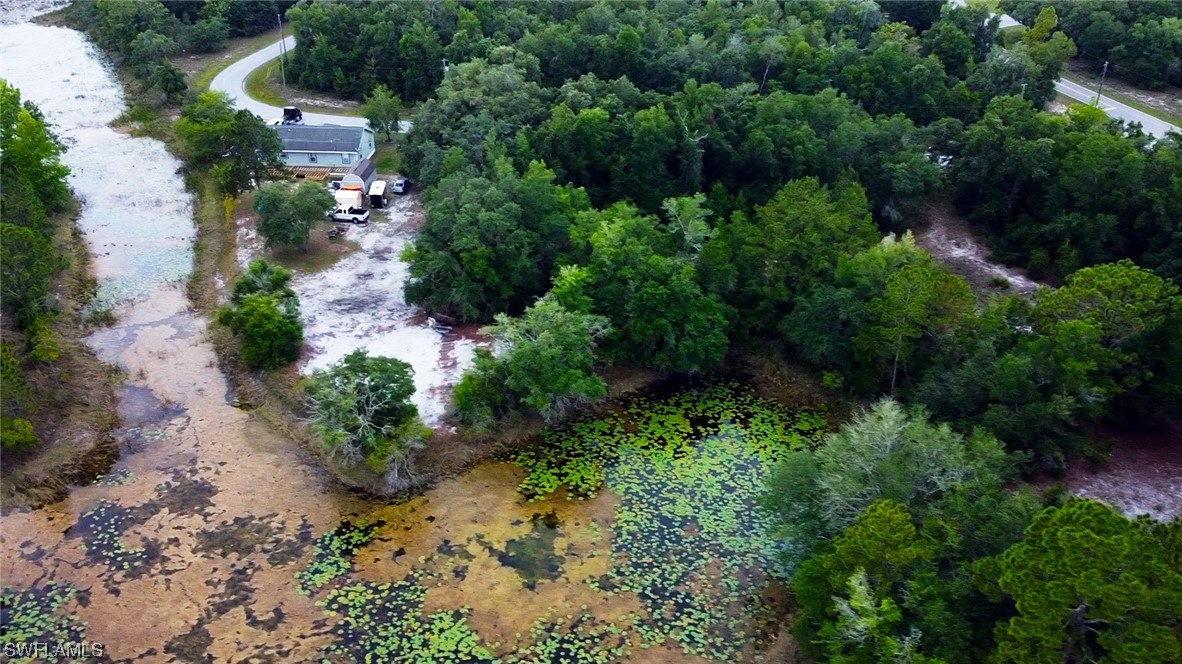 34132 August Avenue Webster, FL 33597 - Photo 3 of 13 an aerial view of a house with a yard and lake view