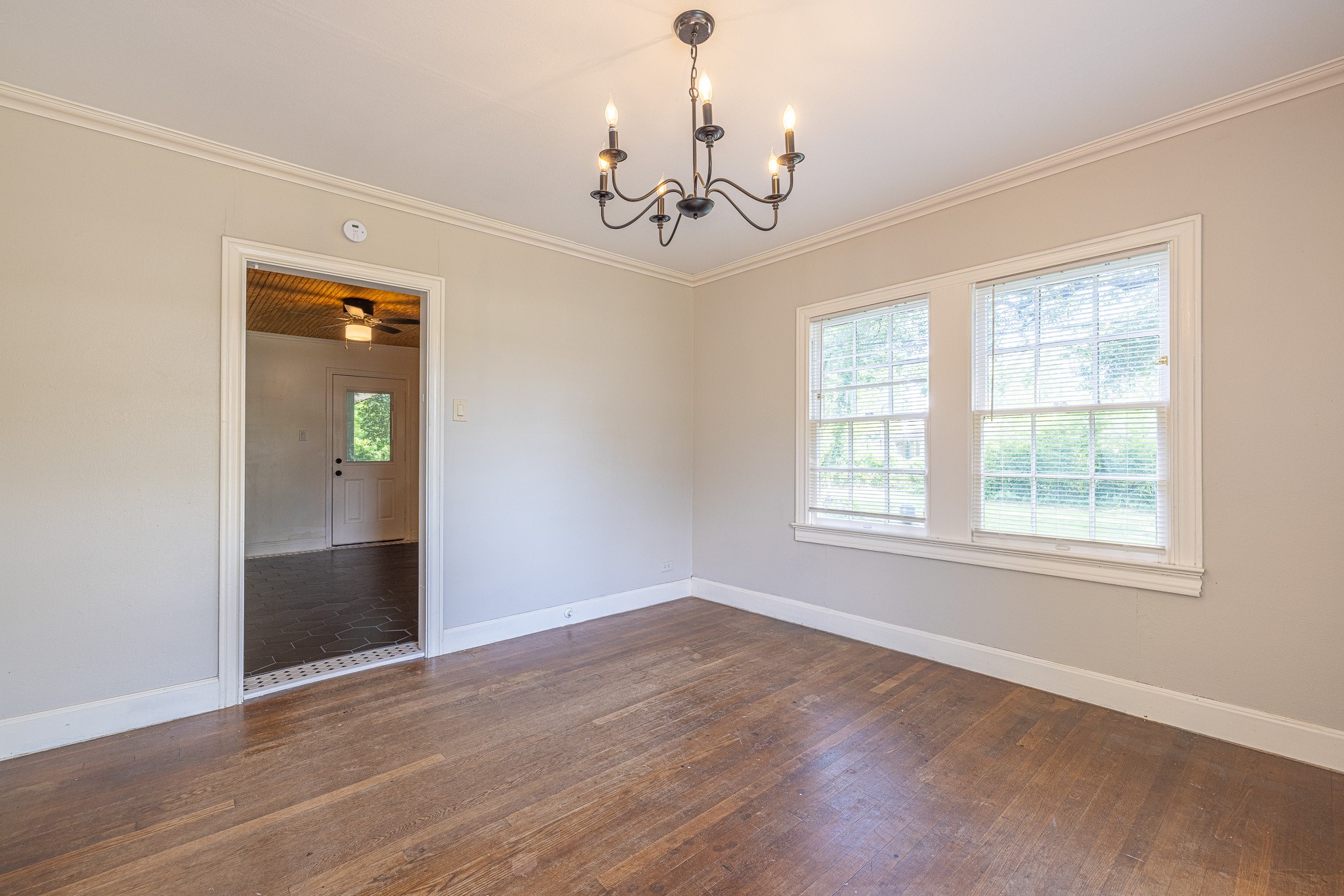 8548 Findlay Street Houston, TX 77017 - Photo 11 of 50 an empty room with wooden floor chandelier and windows