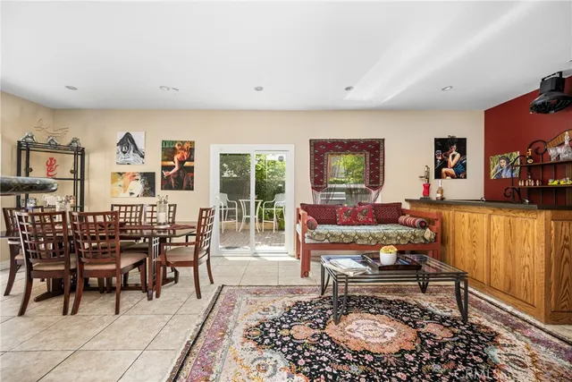 a living room with furniture a flat screen tv and a table