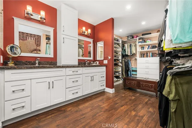 a view of walk in closet with clothes and shoes