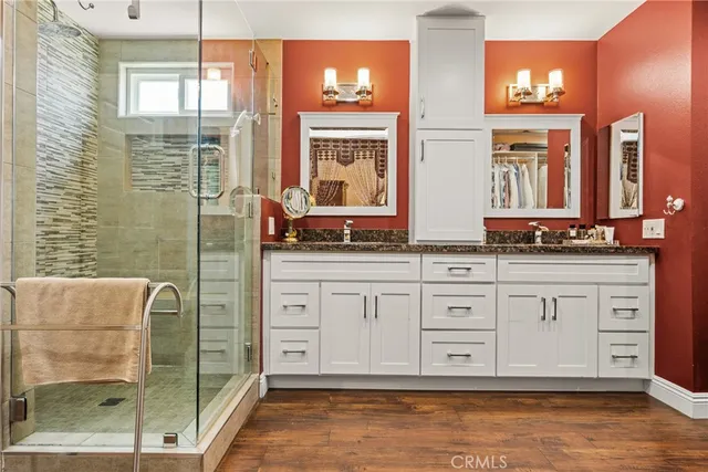 a bathroom with double vanity and a mirror