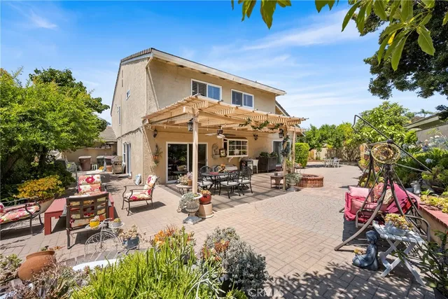 a view of a patio with table and chairs and potted plants