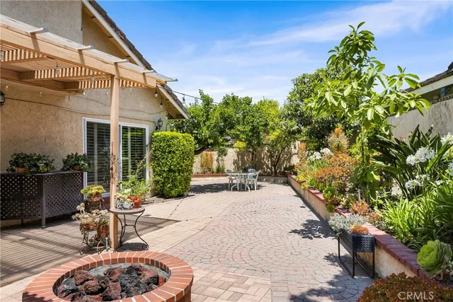 a view of a patio with table and chairs and potted plants