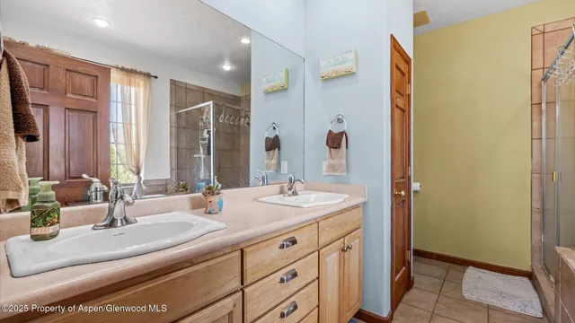 a bathroom with a double vanity sink and a mirror