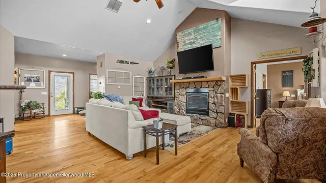a living room with fireplace furniture and a flat screen tv