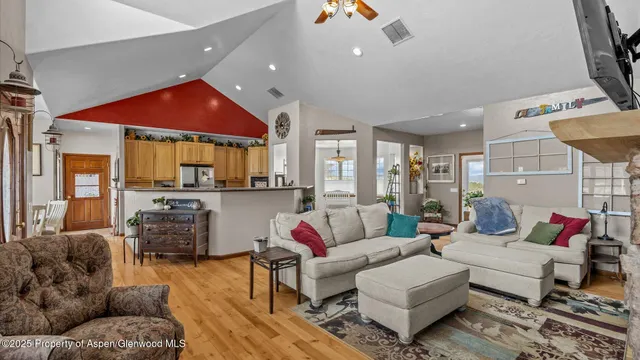 a living room with furniture a rug and a chandelier