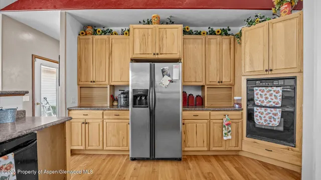 a kitchen with stainless steel appliances a refrigerator and a stove top oven