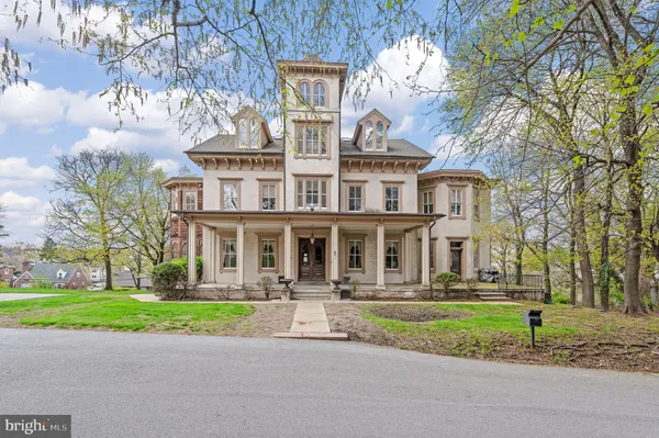 a front view of building with yard and green space