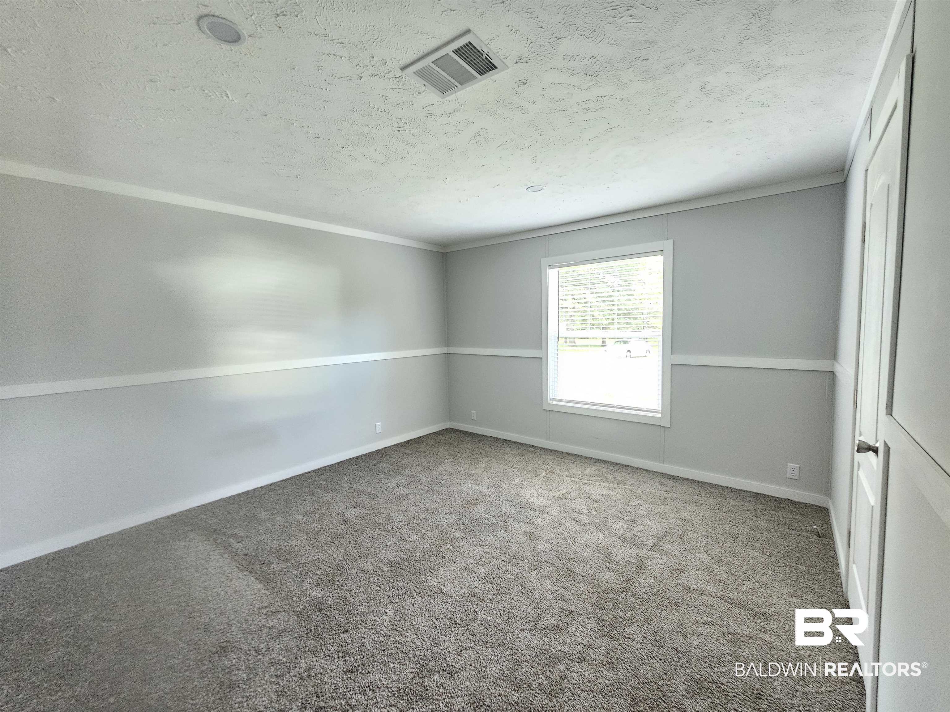 1863 Wait Road Monroeville, AL 36460 - Photo 11 of 38 Empty room with carpet floors and a textured ceiling