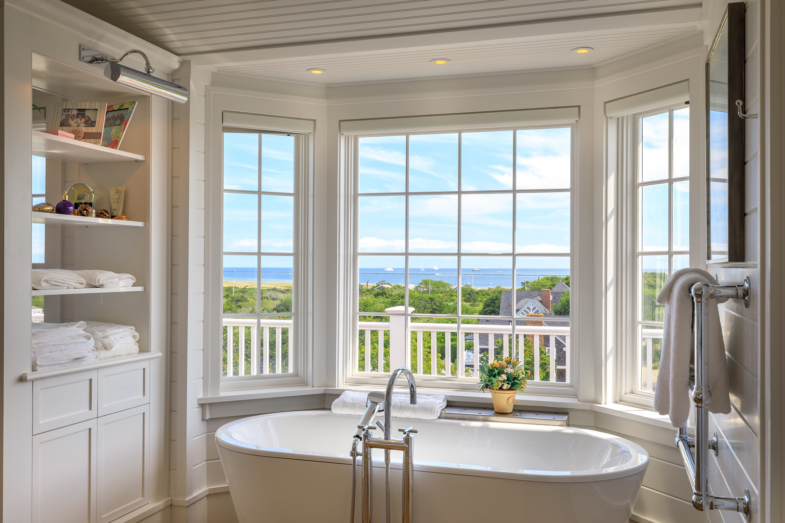 45 Cliff Road Nantucket, MA 02554 - Photo 24 of 36 a dining room with large glass windows and a table