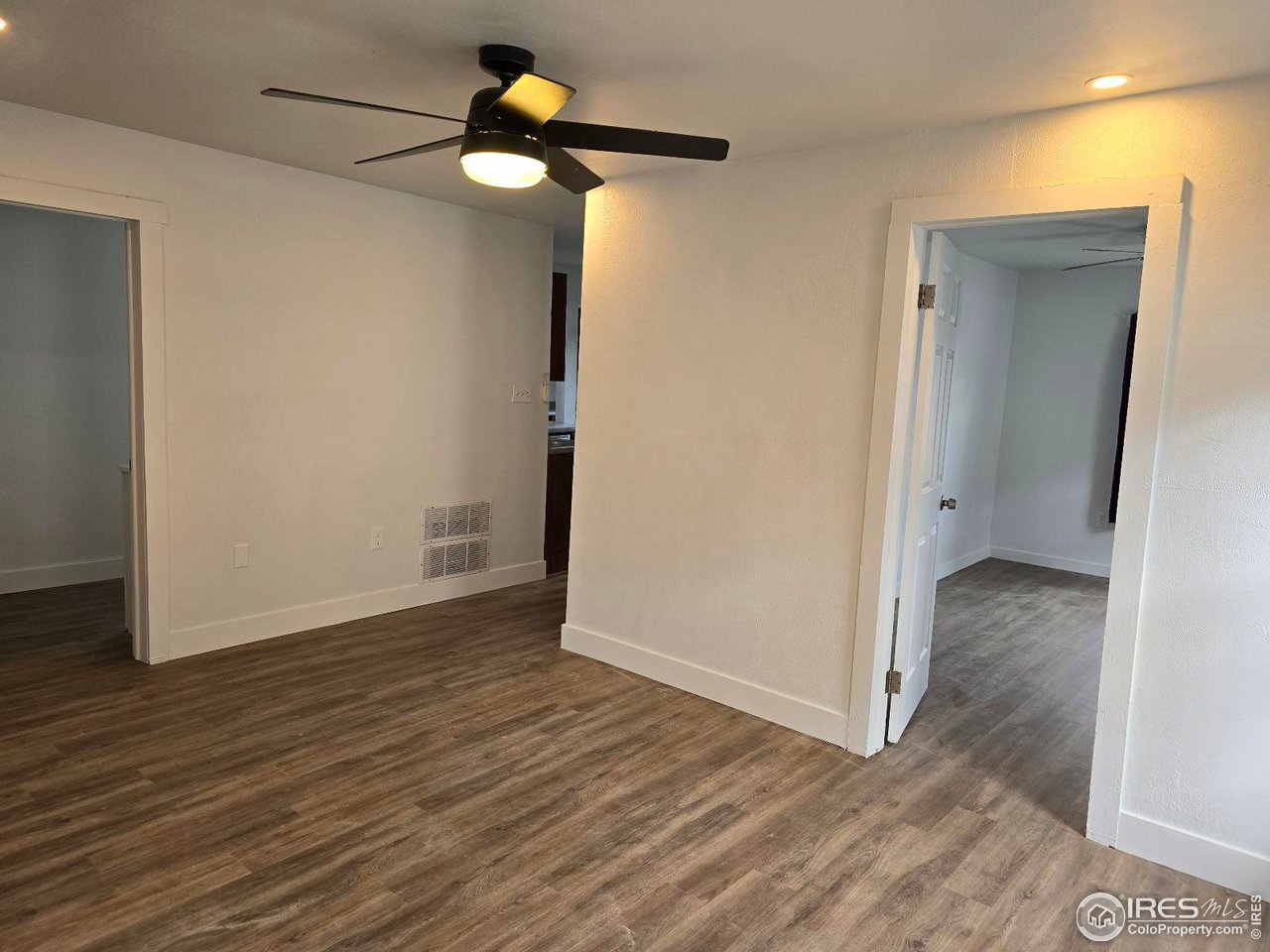 1324 7th Avenue Greeley, CO 80631 - Photo 13 of 22 a view of an empty room with wooden floor
