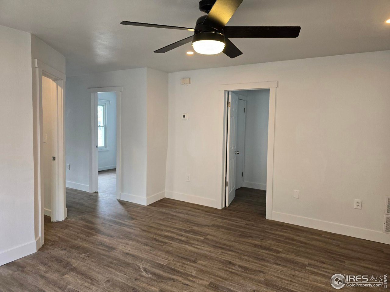 1324 7th Avenue Greeley, CO 80631 - Photo 14 of 22 a view of an empty room and wooden floor