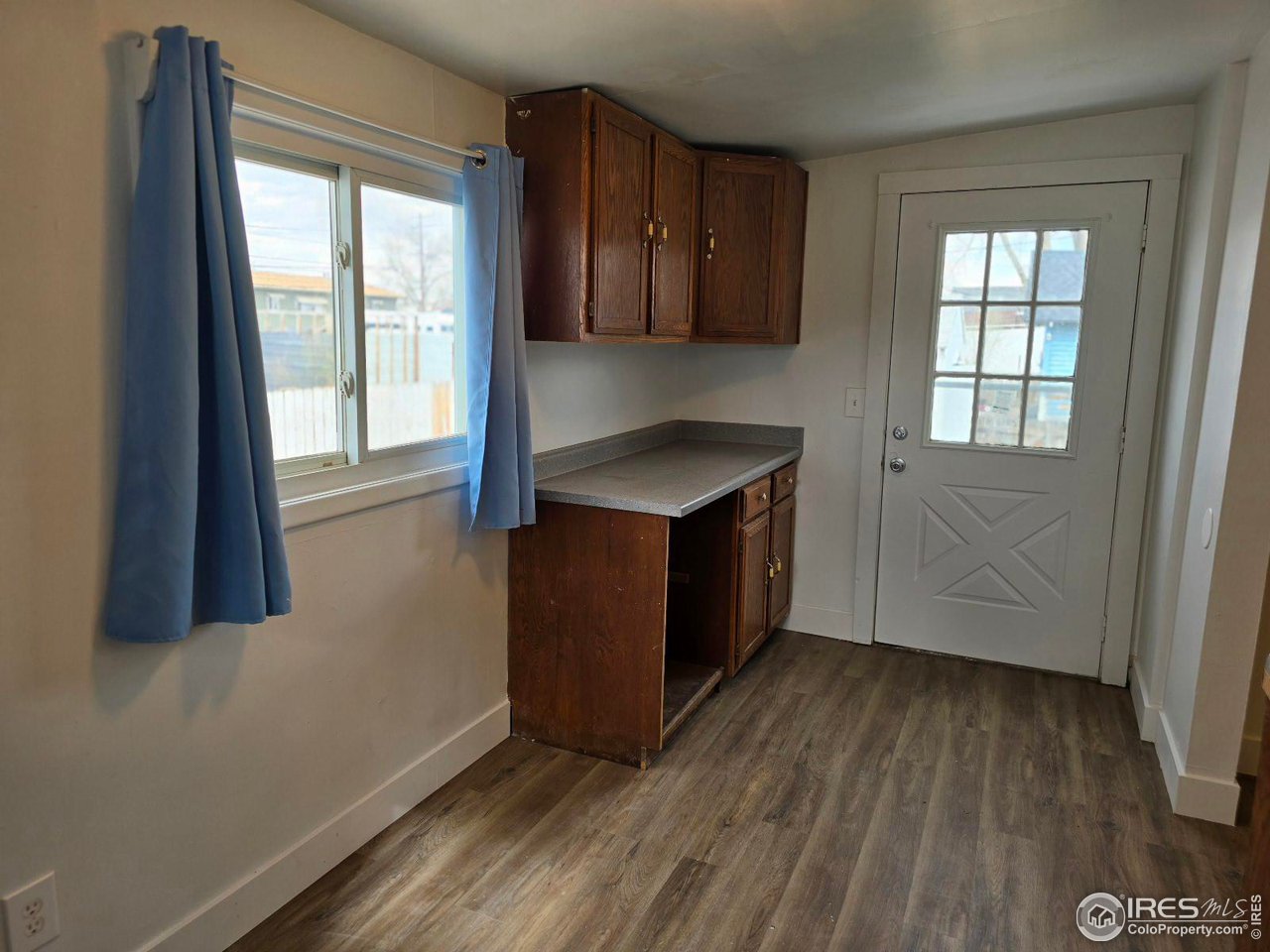 1324 7th Avenue Greeley, CO 80631 - Photo 16 of 22 a room with wooden floor and a window