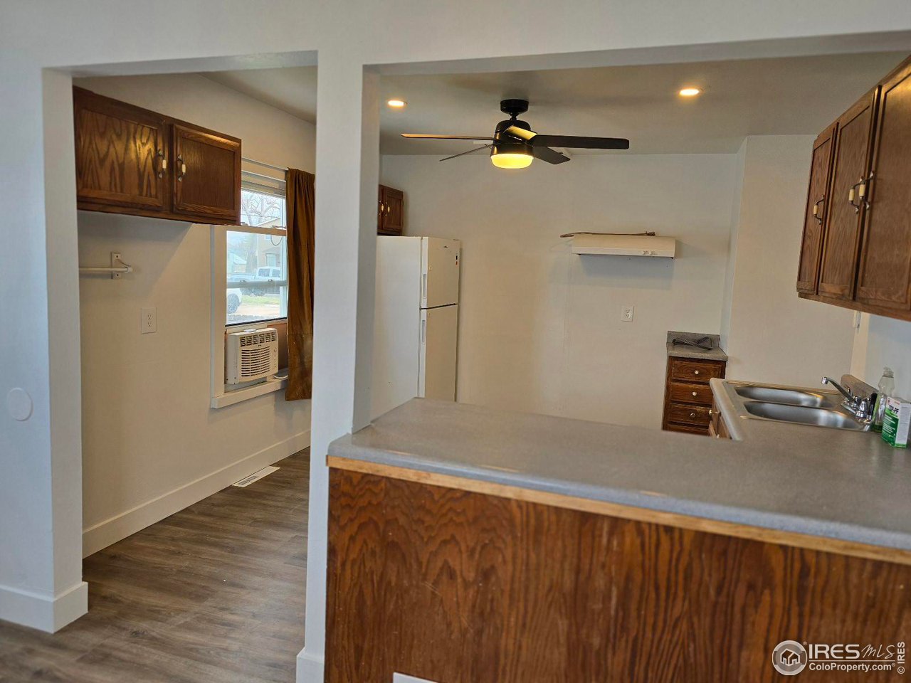 1324 7th Avenue Greeley, CO 80631 - Photo 17 of 22 a kitchen with a refrigerator and a sink