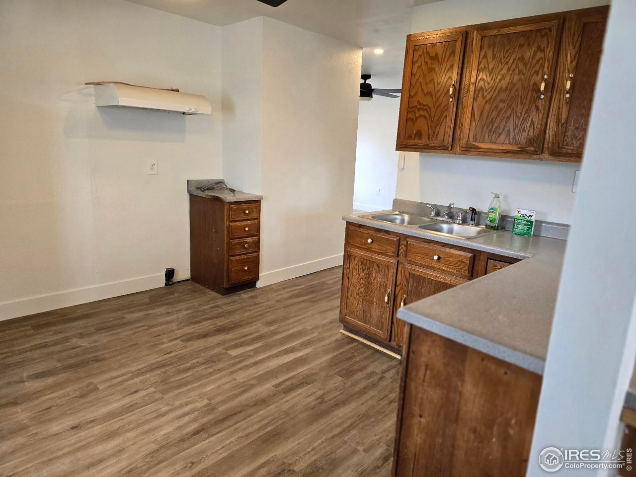 1324 7th Avenue Greeley, CO 80631 - Photo 18 of 22 a kitchen with a cabinets and wooden floor