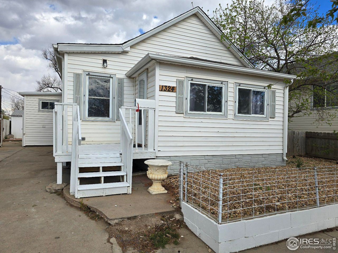 1324 7th Avenue Greeley, CO 80631 - Photo 2 of 22 a view of a house with more windows and wooden fence