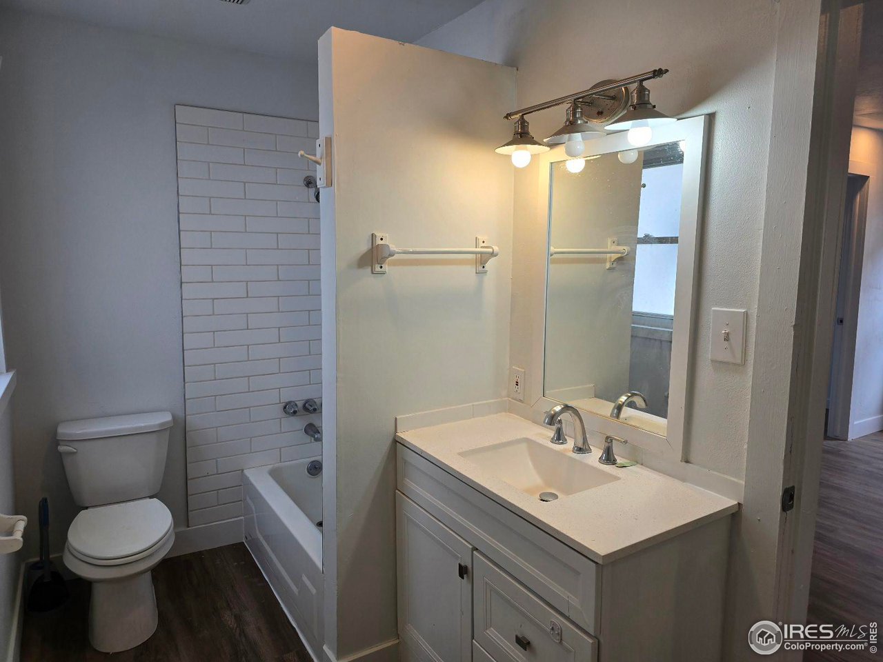1324 7th Avenue Greeley, CO 80631 - Photo 8 of 22 a bathroom with a sink toilet and shower