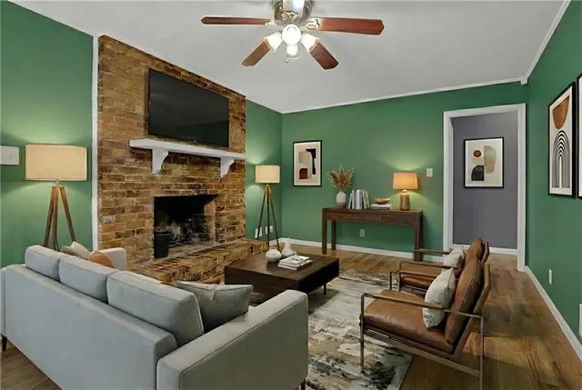 a living room with furniture a flat screen tv and a fireplace
