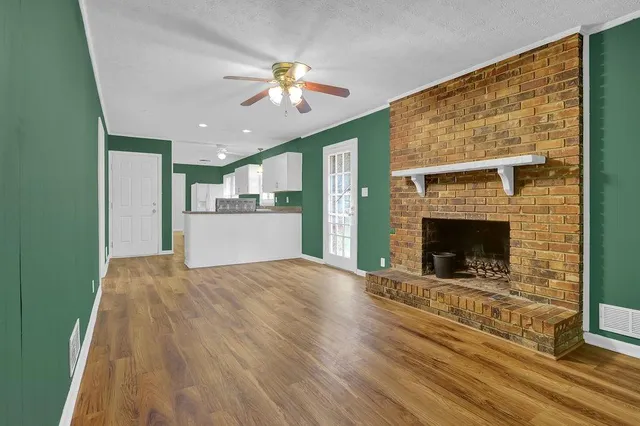 a view of a kitchen with a fireplace a sink and a chandelier