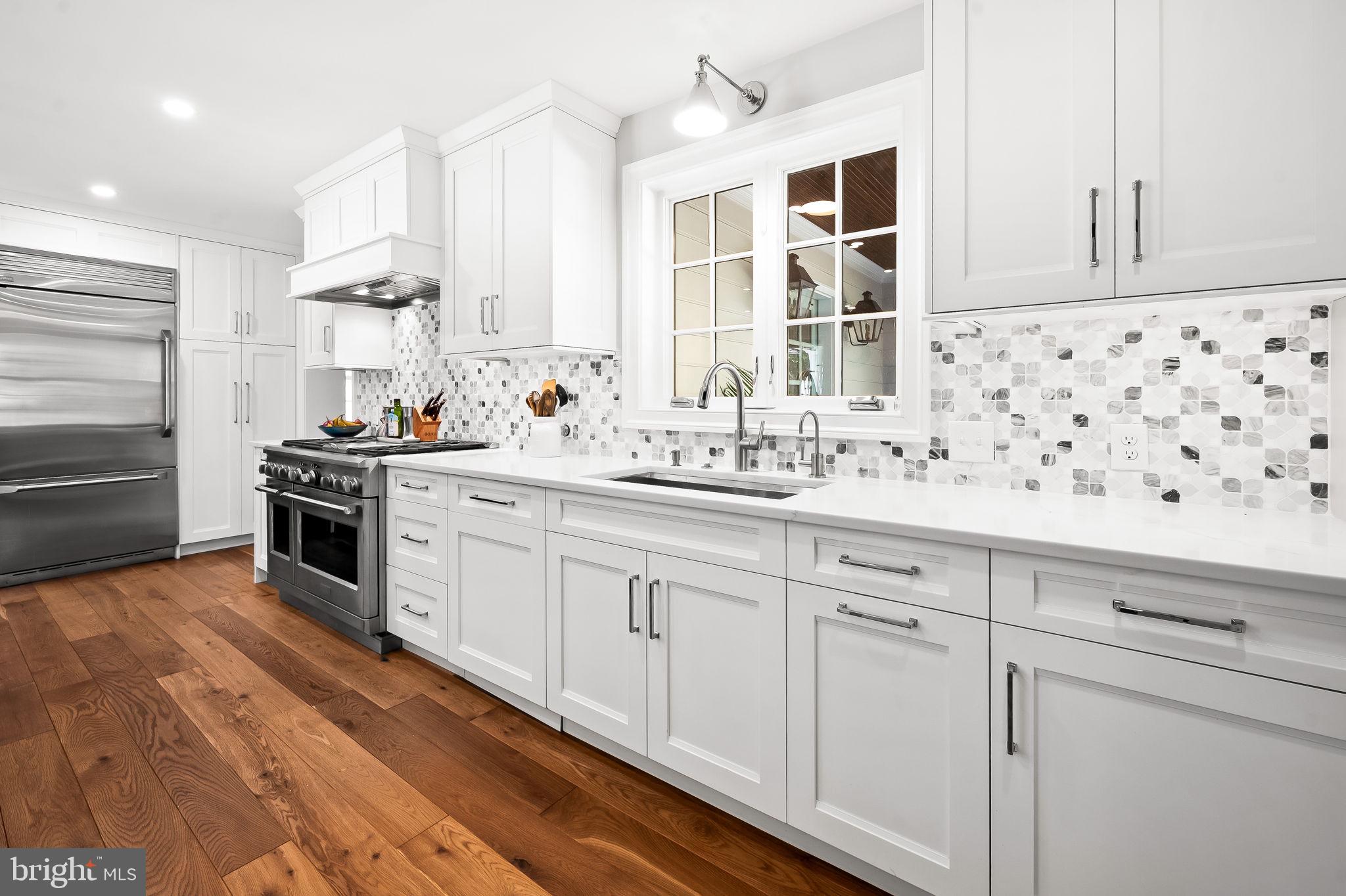 1719 Thornton Ridge Road Baltimore, MD 21204 - Photo 14 of 36 a kitchen with granite countertop white cabinets and white appliances