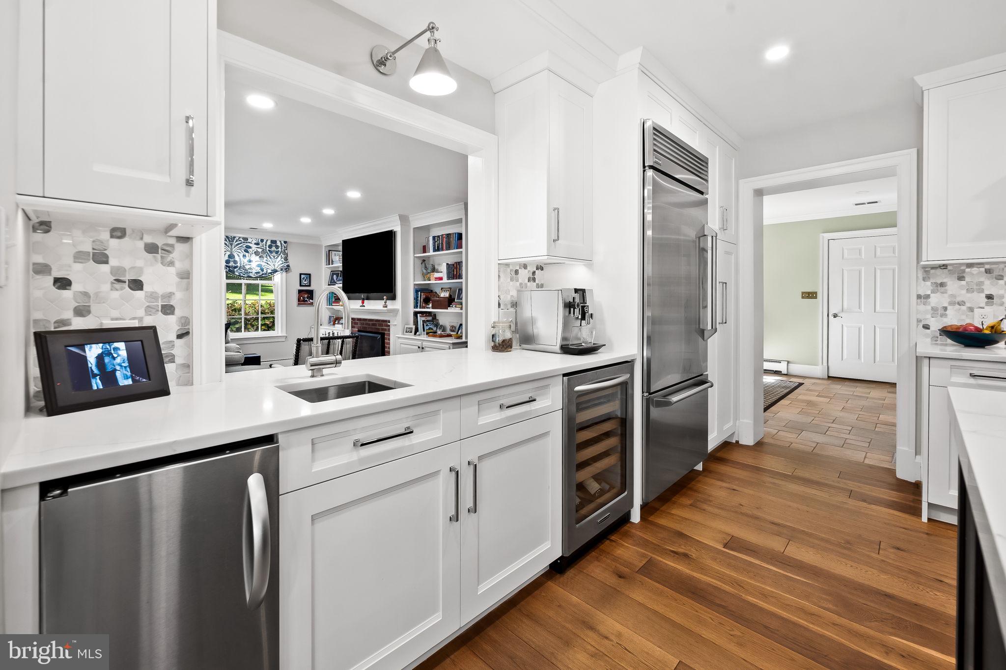 1719 Thornton Ridge Road Baltimore, MD 21204 - Photo 15 of 36 a large kitchen with a large counter top a sink stainless steel appliances and cabinets