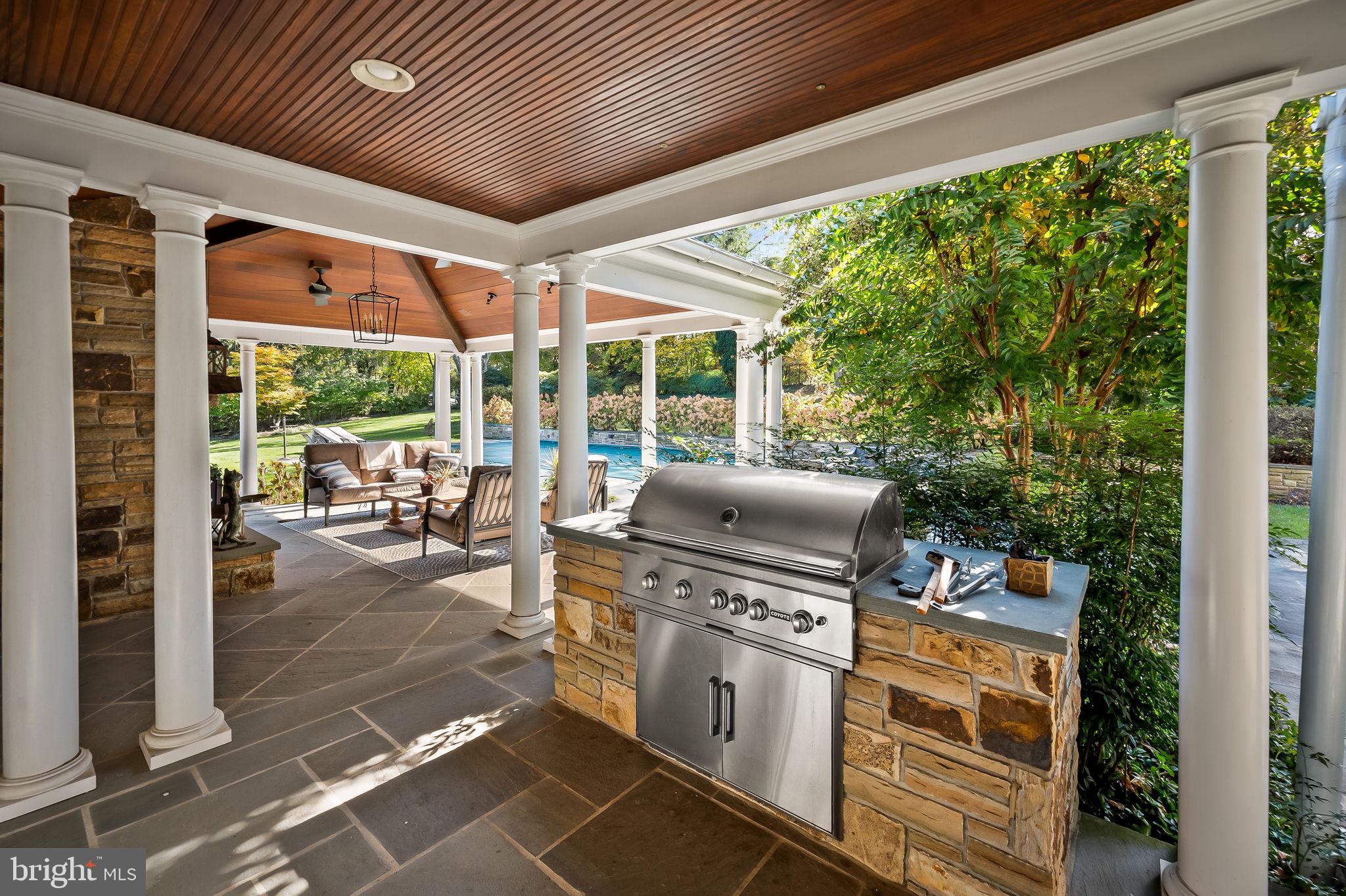 1719 Thornton Ridge Road Baltimore, MD 21204 - Photo 21 of 36 a view of a patio with table and chairs potted plants with floor to ceiling window