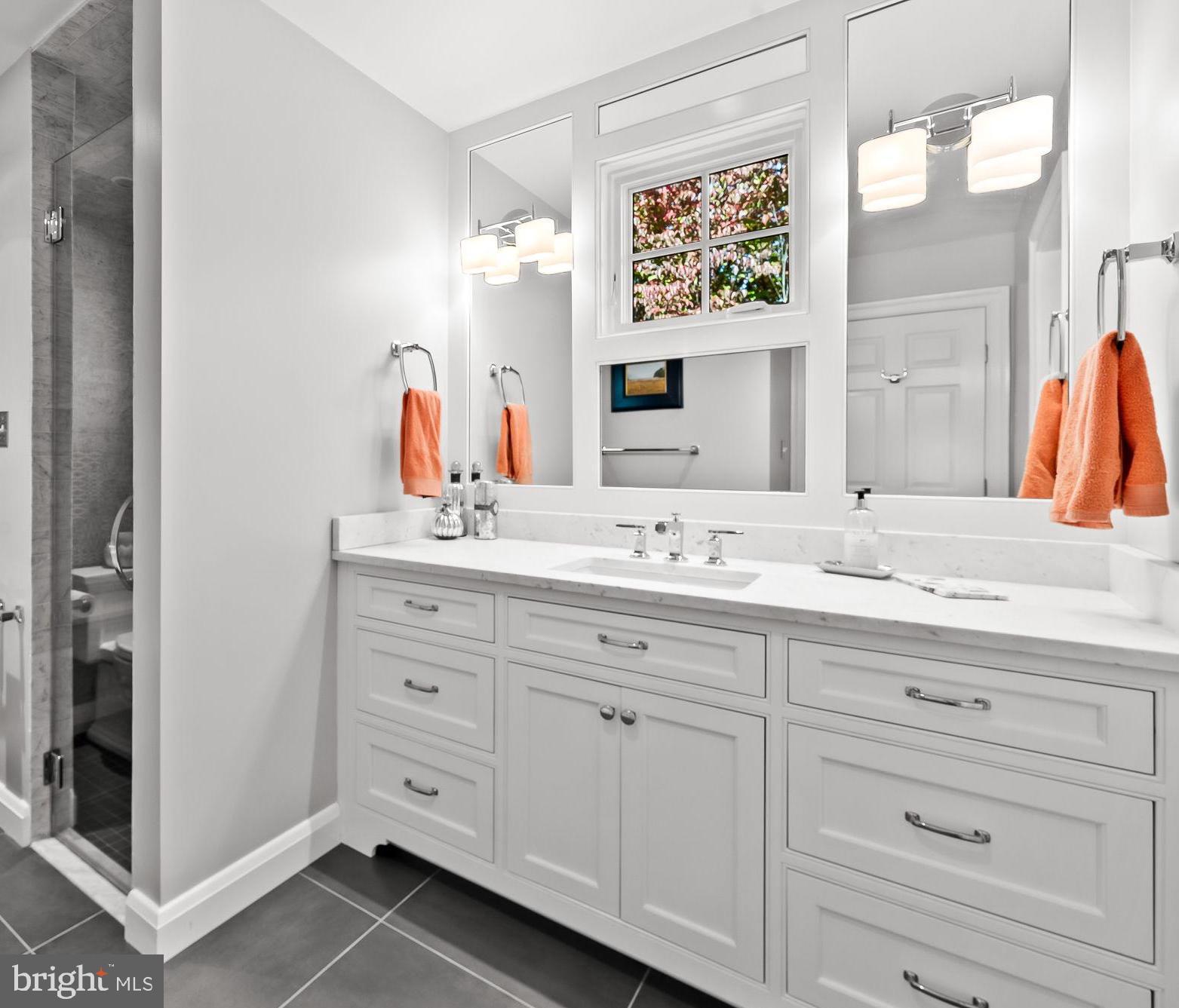 1719 Thornton Ridge Road Baltimore, MD 21204 - Photo 26 of 36 a bathroom with a double vanity sink and a mirror
