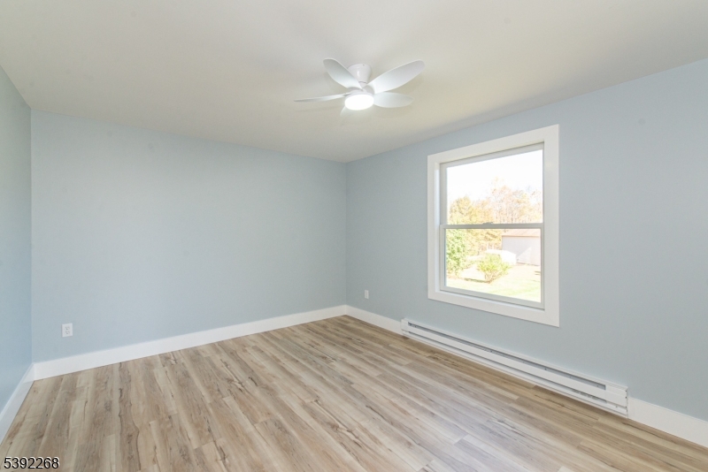 23 George Hill Road Augusta, NJ 07822 - Photo 11 of 19 an empty room with a window and a ceiling fan