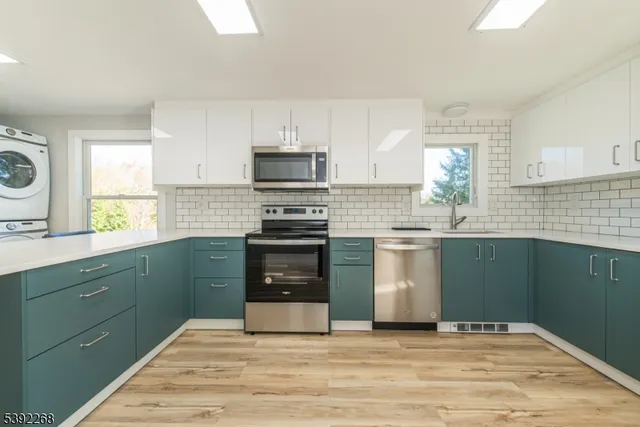 a kitchen with a sink stove and microwave
