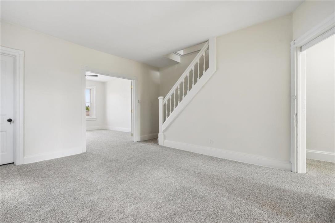 812 Linden Street Bethlehem, PA 18018 - Photo 14 of 39 A spacious, naturally illuminated room featuring a stairway and plush gray carpeting.