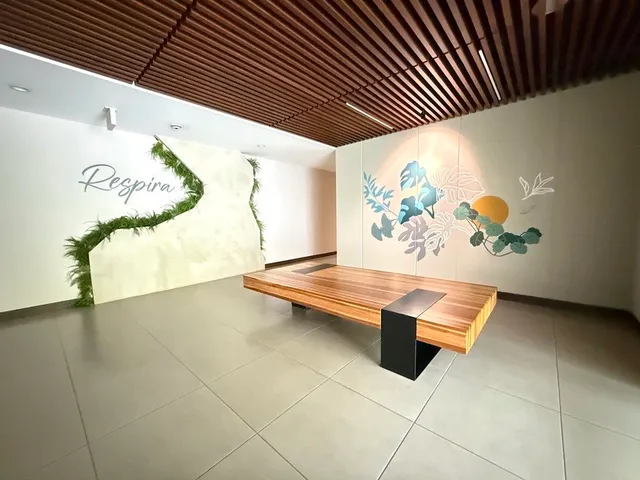 a front view of a house with plants and trees