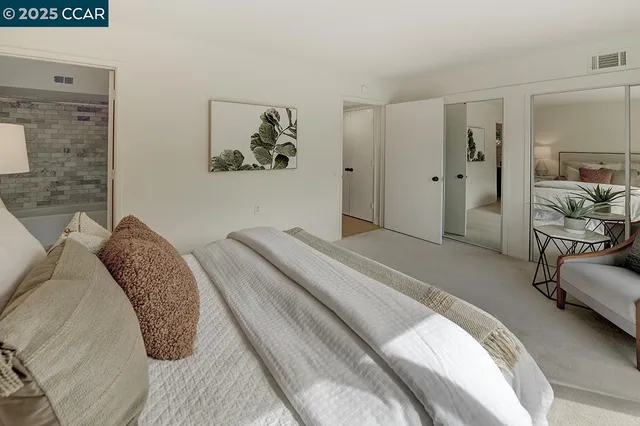 a bedroom with a bed and a view of bathroom