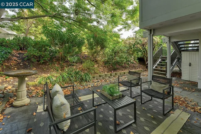 a view of a yard with plants and outdoor seating
