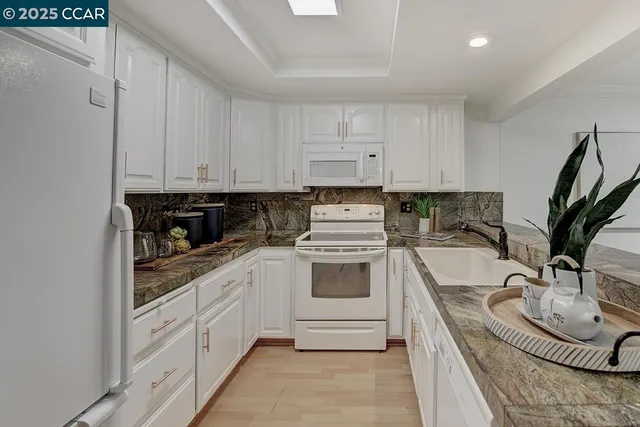 a view of a dining room with furniture large windows and wooden floor