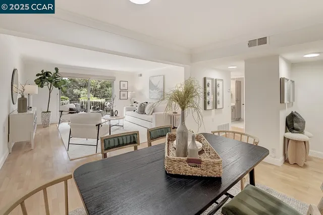 a living room with furniture a rug and a large window