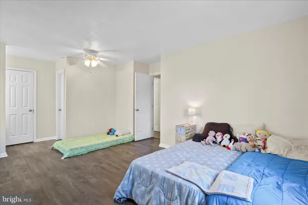 an empty room with a window and a ceiling fan