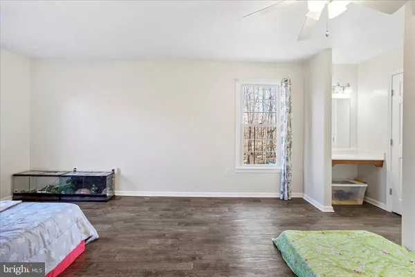 an empty room with a chandelier fan