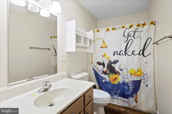 an empty room with windows and chandelier fan