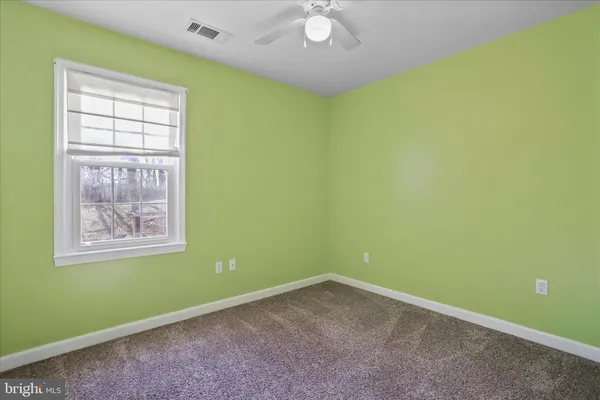a spacious bathroom with a granite countertop sink toilet and shower
