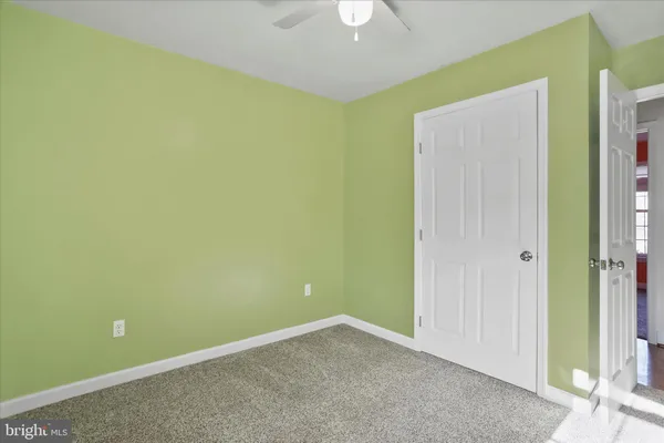 a bedroom with a bed and a lamp on table