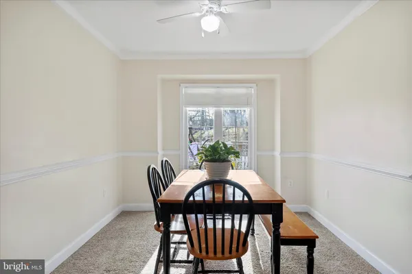 a living room with furniture and a painting on the wall