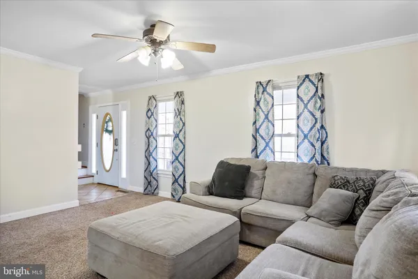 a kitchen with kitchen island granite countertop a stove sink cabinets and microwave