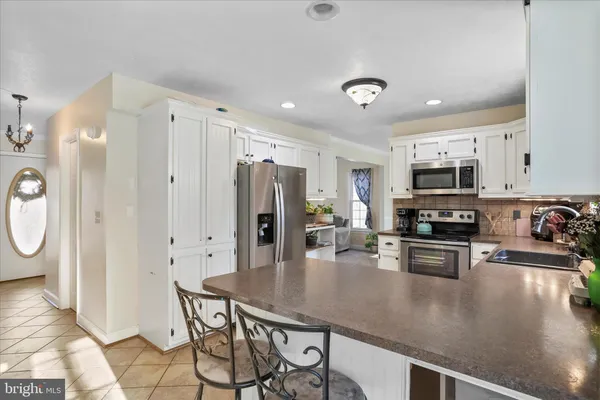a view of yard covered with snow in front of house