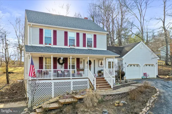 a view of a hallway with wooden floor and a potted plant