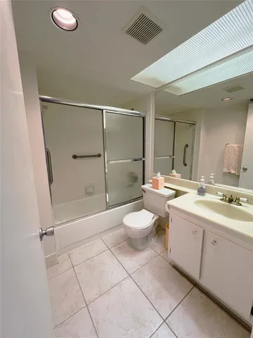 a bathroom with a double vanity sink toilet and shower
