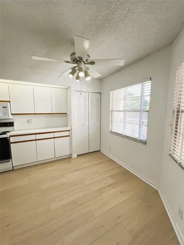 a view of an empty room with a kitchen